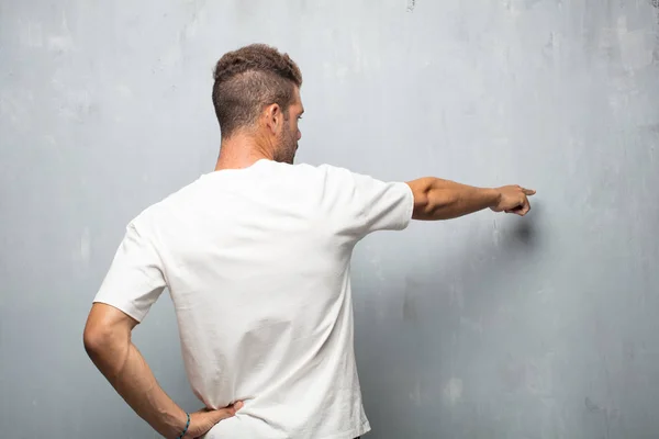 Giovane Uomo Bello Vista Posteriore Mano Sul Fianco Graffiare Testa — Foto Stock