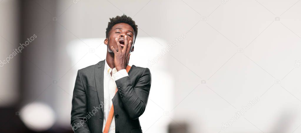 young black businessman Looking unenthusiastic and bored, listening to something dull and tedious, yawning in utter boredom.