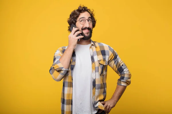 young crazy mad man in fool pose with a smart mobile phone