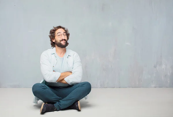 Young Cool Bearded Man Sitting Floor Grunge Wall Background — Stock Photo, Image
