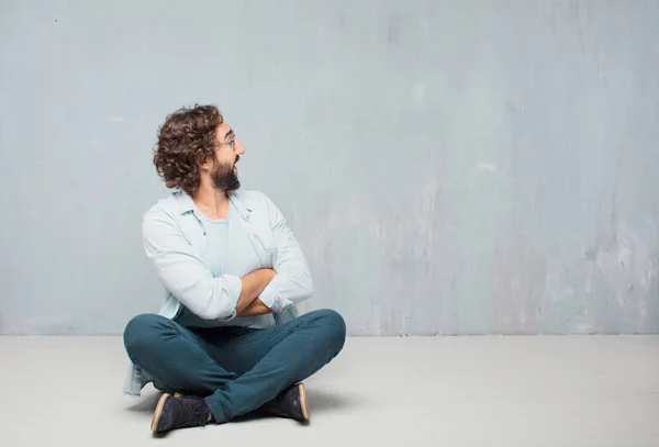 Young Cool Bearded Man Sitting Floor Grunge Wall Background — Stock Photo, Image