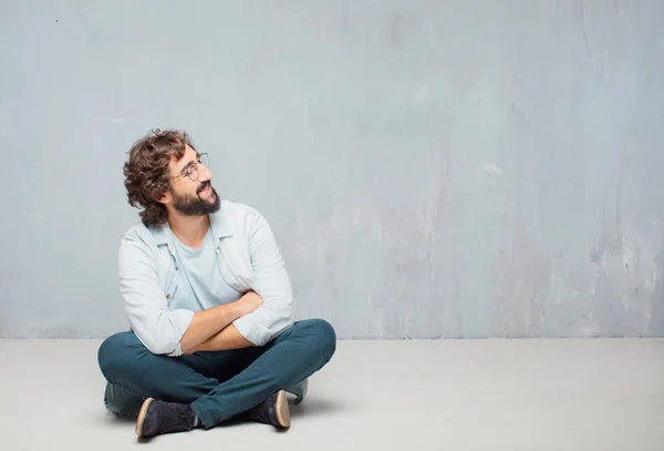 Junger Kühler Bärtiger Mann Auf Dem Boden Sitzend Grunge Wall — Stockfoto