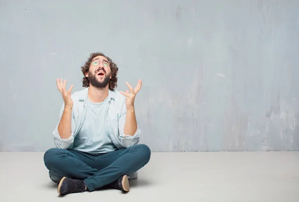 Young Cool Bearded Man Sitting Floor Grunge Wall Background — Stock Photo, Image