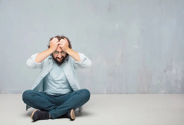 Young Cool Bearded Man Sitting Floor Grunge Wall Background — Stock Photo, Image