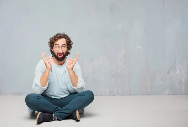 Young Cool Bearded Man Sitting Floor Grunge Wall Background — Stock Photo, Image