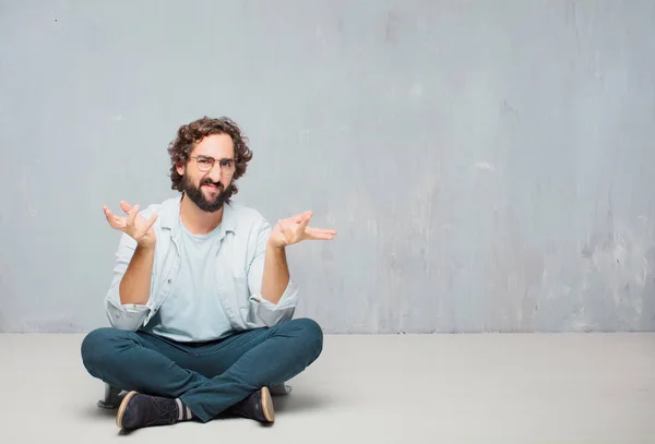 Young Cool Bearded Man Sitting Floor Grunge Wall Background — Stock Photo, Image