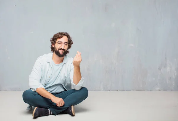Young Cool Bearded Man Sitting Floor Grunge Wall Background — Stock Photo, Image