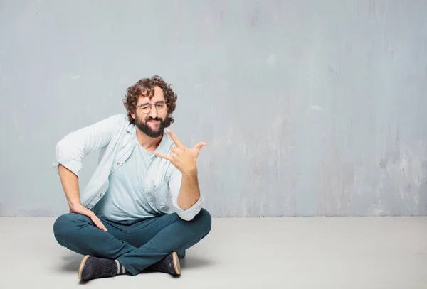 Young Cool Bearded Man Sitting Floor Grunge Wall Background — Stock Photo, Image