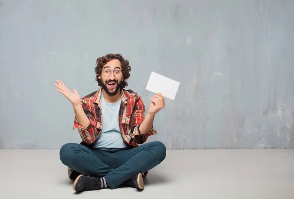 young crazy mad man in fool pose holding a placard