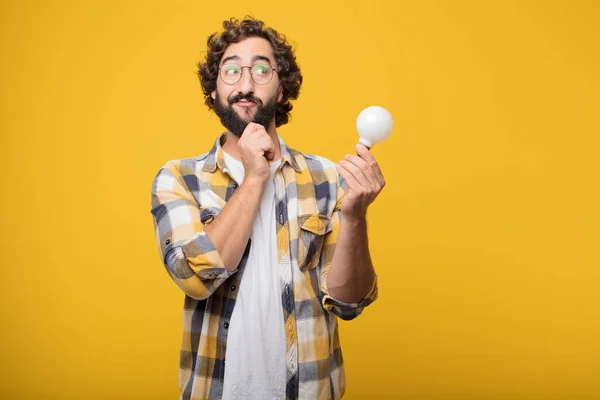 young crazy mad man in fool pose with a light bulb. Idea or inspiration concept.