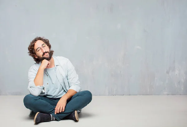 Young Cool Bearded Man Sitting Floor Grunge Wall Background — Stock Photo, Image