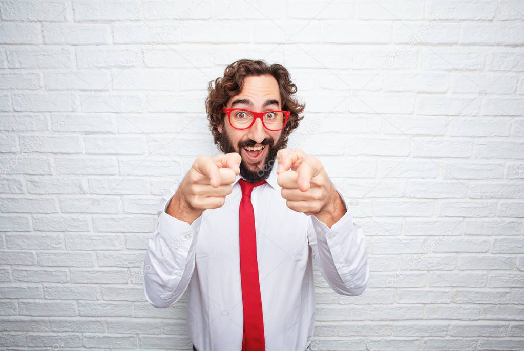 Crazy businessman expressing a concept. Brick wall background.