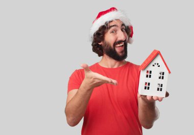 Ev modeli olan genç deli adam. Noel kavramı.