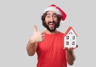 Ev modeli olan genç deli adam. Noel kavramı.