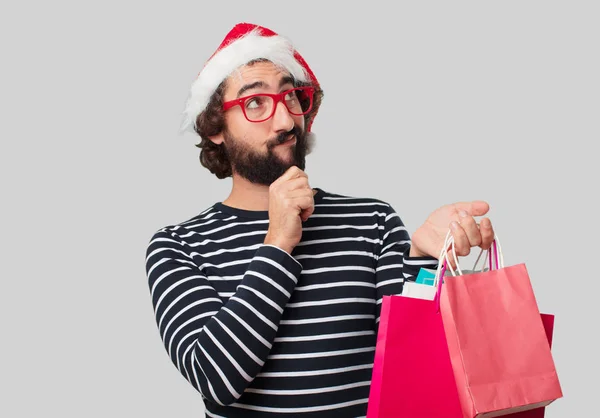 Young crazy man with shopping bags. Christmas concept.