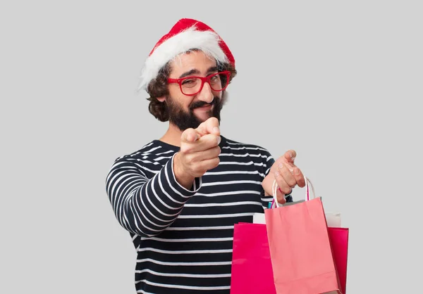 Young crazy man with shopping bags. Christmas concept.