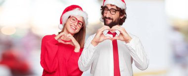Genç çift ifade Noel kavramı. Çift ve arka planda farklı katmanları.