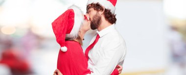 Genç çift ifade Noel kavramı. Çift ve arka planda farklı katmanları.