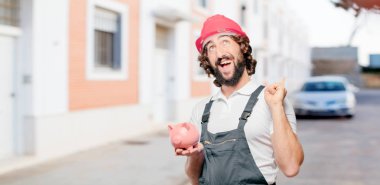 Kumbarası olan genç bir işçi.