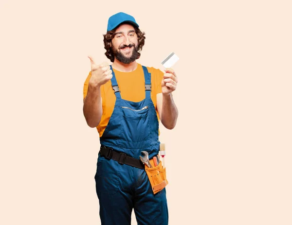 Handyman worker with a credit card — Stock Photo, Image