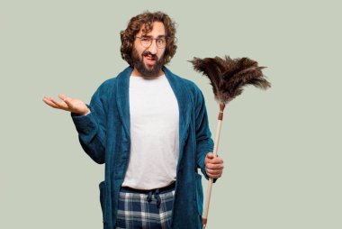 Bornoz giyip, toz bezi giyen genç adam.