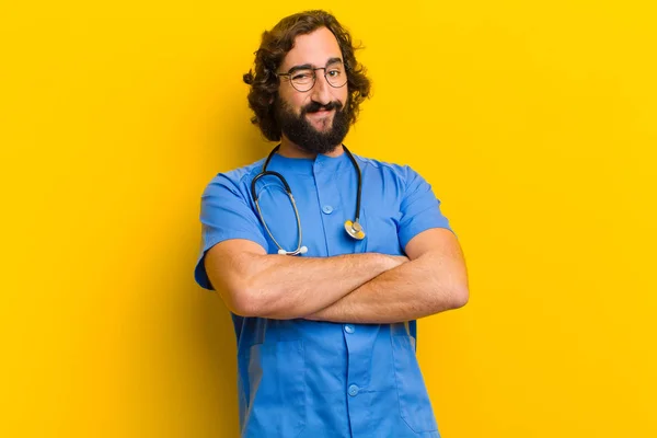 young nurse man in proud pose against yellow background