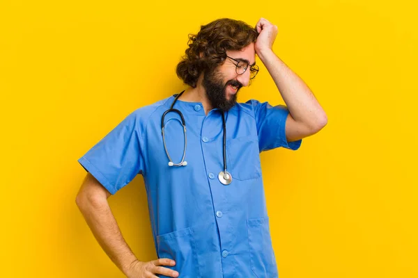 young nurse man thinking against yellow background