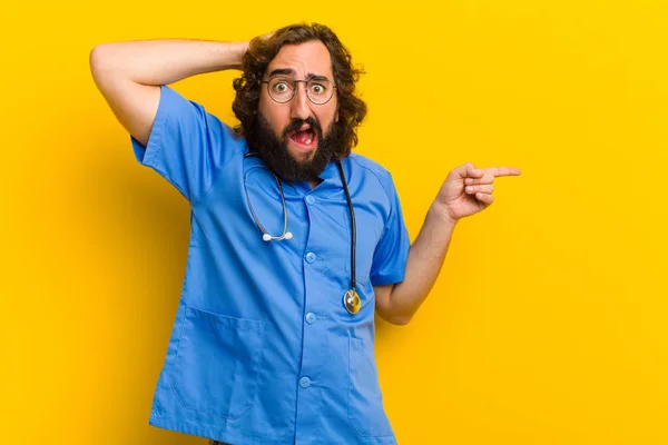 young nurse man in scared pose