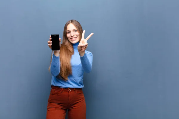 Young Pretty Woman Using Smart Phone Blue Wall Copy Space — Stock Photo, Image