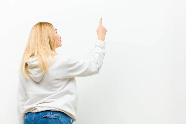 Young Blonde Woman Standing Pointing Object Copy Space Rear View — Stock Photo, Image