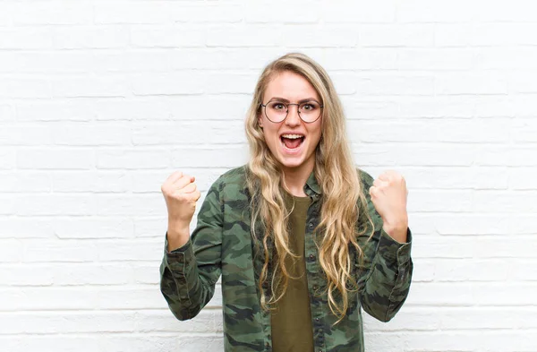 Young Blonde Woman Shouting Aggressively Angry Expression Fists Clenched Celebrating — Stock Photo, Image