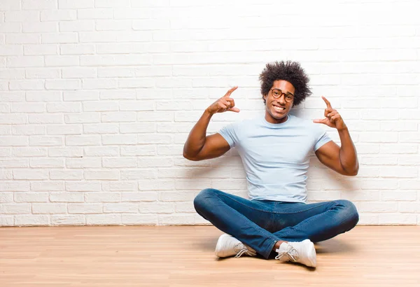 Joven Hombre Negro Enmarcando Esbozando Propia Sonrisa Con Ambas Manos —  Fotos de Stock