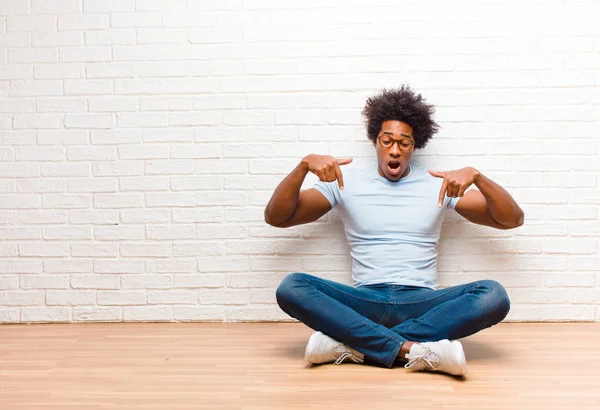 Young Black Man Open Mouth Pointing Downwards Both Hands Looking — 스톡 사진