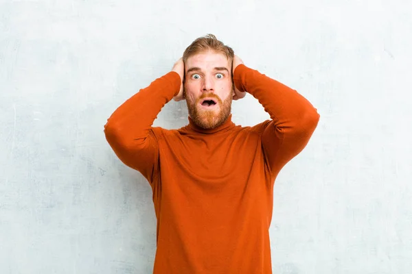 Young Red Head Man Wearing Turtle Neck Looking Unpleasantly Shocked — Stock Photo, Image