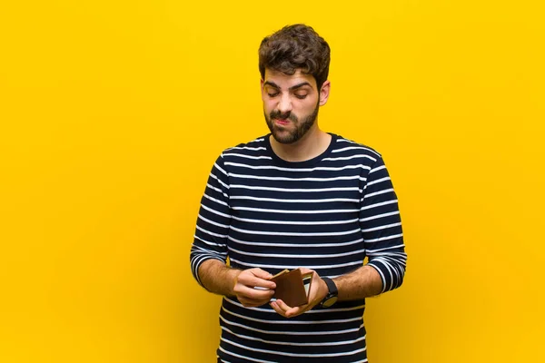 Jovem homem bonito contra fundo laranja — Fotografia de Stock