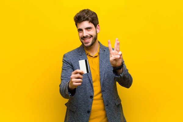 Jovem homem bonito contra fundo laranja — Fotografia de Stock