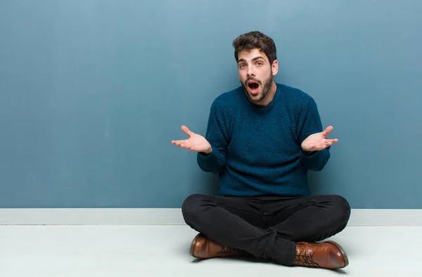 Young Handsome Man Sitting Floor Open Mouthed Amazed Shocked Astonished — Stockfoto