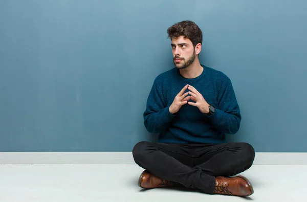 Young Handsome Man Sitting Floor Scheming Conspiring Thinking Devious Tricks — Stock Photo, Image