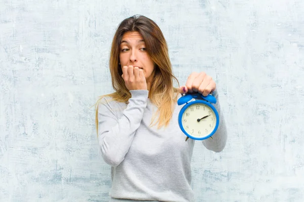 Young Pretty Woman Alarm Clock Grunge Wall — Stock Photo, Image