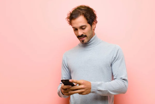 Young Handsome Man Smart Phone Pink Flat Wall — Stockfoto