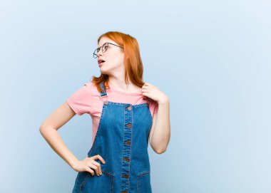 Genç kızıl saçlı güzel bir kadın stresli, endişeli, yorgun ve hayal kırıklığına uğramış, gömleğini çekiştiren, sorunlardan bıkmış görünüyor.