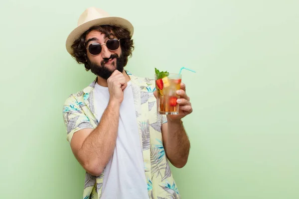 young crazy bearded man with a cocktail. tourist concept