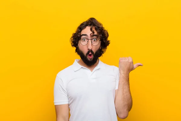 Young Crazy Man Looking Astonished Disbelief Pointing Object Side Saying — Stockfoto