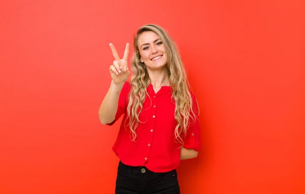 Young Blonde Woman Smiling Looking Happy Carefree Positive Gesturing Victory — Stock Photo, Image