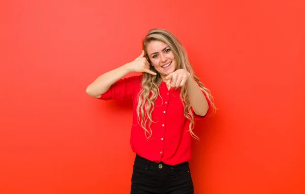Young Blonde Woman Smiling Cheerfully Pointing Camera While Making Call — Stock Photo, Image