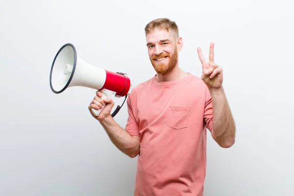 Jonge Rode Hoofd Man Met Een Megafoon Tegen Witte Achtergrond — Stockfoto