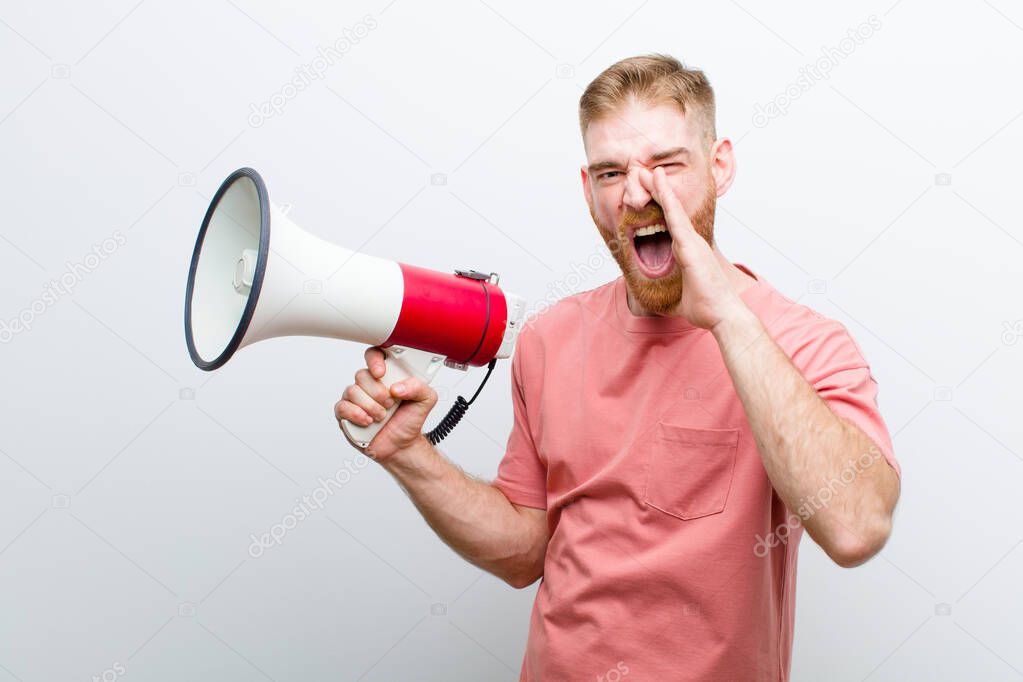young red head man with a megaphone against white background