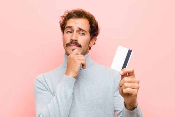 Young Handsome Man Credit Card Pink Flat Wall — Stock Photo, Image