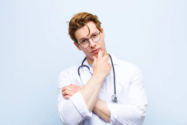 Young Red Head Doctor Looking Serious Confused Uncertain Thoughtful Doubting — Stock Photo, Image