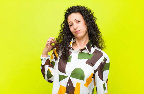 young pretty woman looking arrogant, successful, positive and proud, pointing to self against chroma key wall